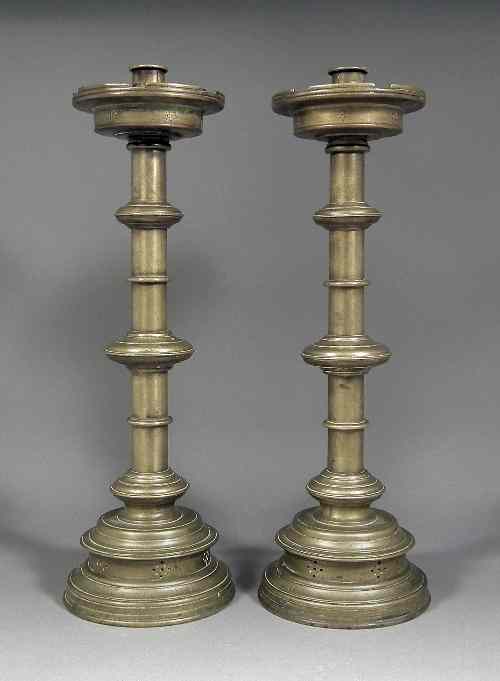 Appraisal: A pair of Victorian brass pillar candlesticks of ''Ecclesiastical'' design