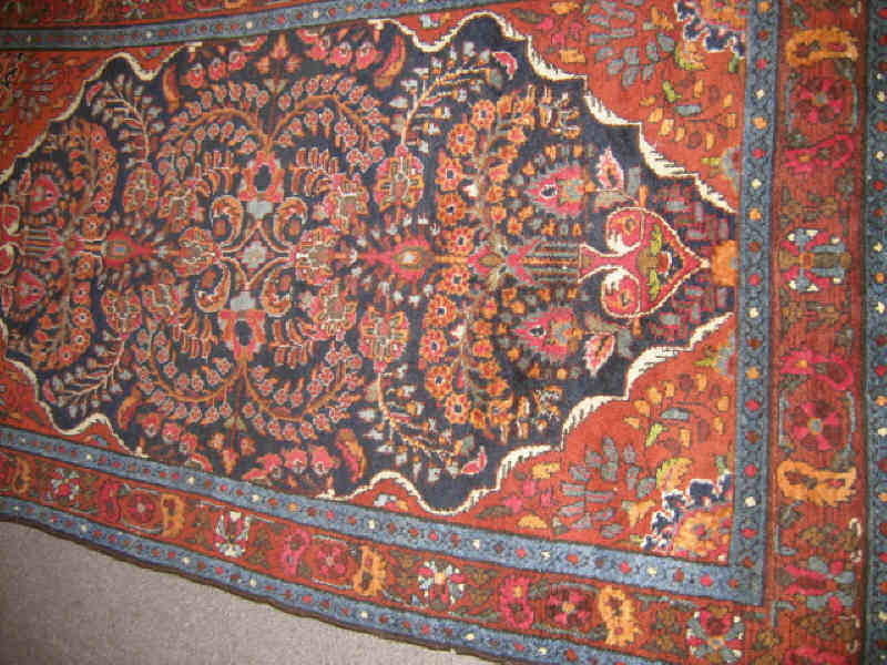 Appraisal: HAMADAN THROW RUG The indigo field of vase and curvilinear