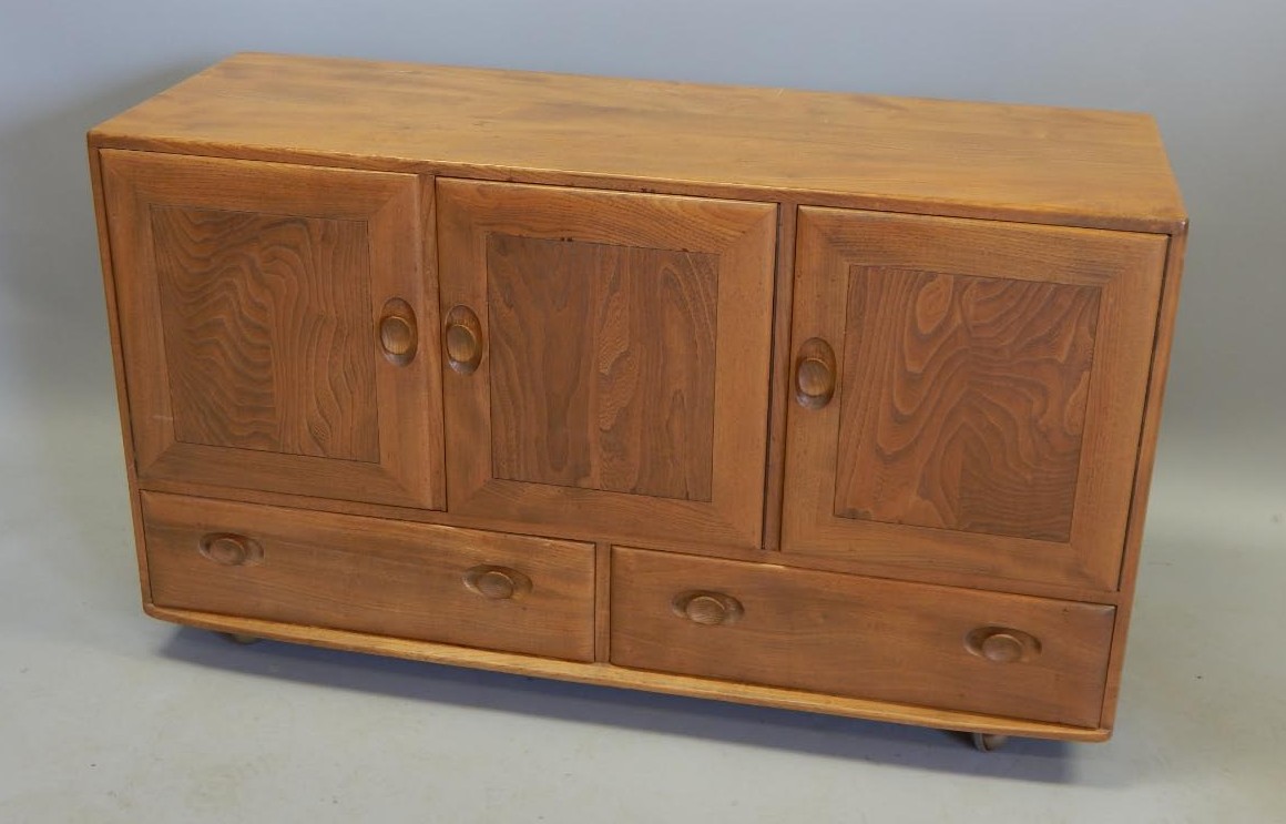 Appraisal: An Ercol light elm Retro style sideboard with three panelled