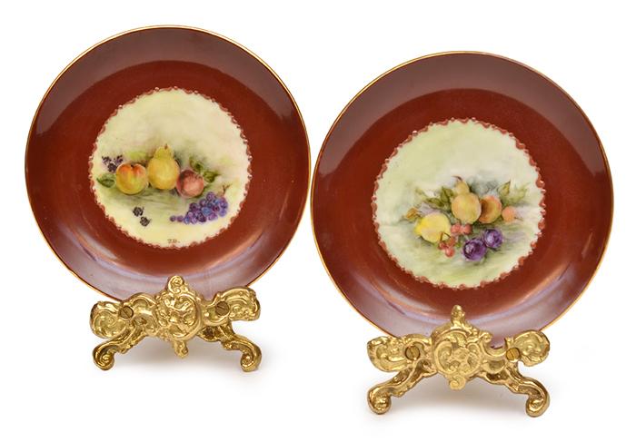 Appraisal: PAIR OF SMALL FRUIT DECORATED PLATES ON STANDS