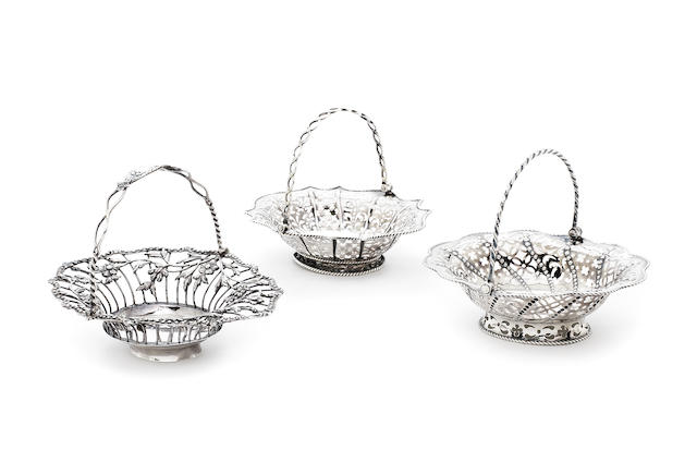 Appraisal: Three George III silver swing-handle sweetmeat baskets One by William