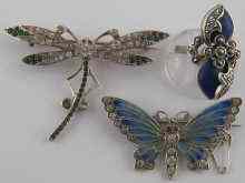 Appraisal: Two white metal tests silver brooches one designed as a