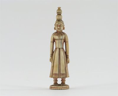 Appraisal: A small Indian ivory standing figure of a woman carrying