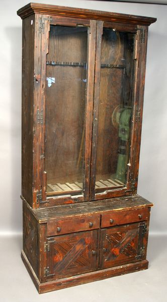 Appraisal: th Century pine two-section gun cabinet h x w x