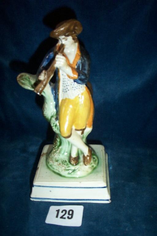 Appraisal: An th century Staffordshire figure of a young man playing