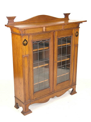 Appraisal: An oak Art Nouveau style display cabinet the arched raised