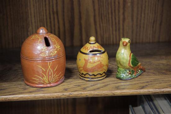 Appraisal: TWO SHOONER REDWARE BANKS AND A BIRD A dome shaped