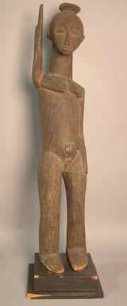 Appraisal: A LOBI CARVED FEMALE FIGURE FROM BURKINA-FASO with raised arm