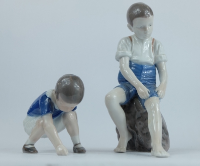 Appraisal: Bing Grondahl porcelain figures of seated boy rolling trousers up