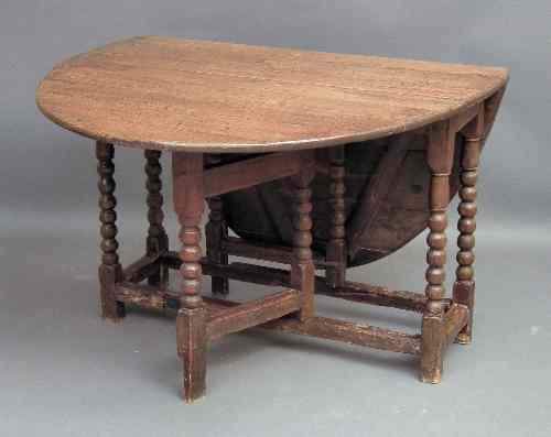 Appraisal: An old oak oval gateleg table on bobbin turned supports