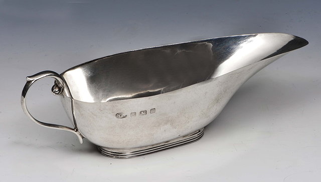 Appraisal: AN EDWARDIAN SILVER PAP BOAT with reeded oval foot and