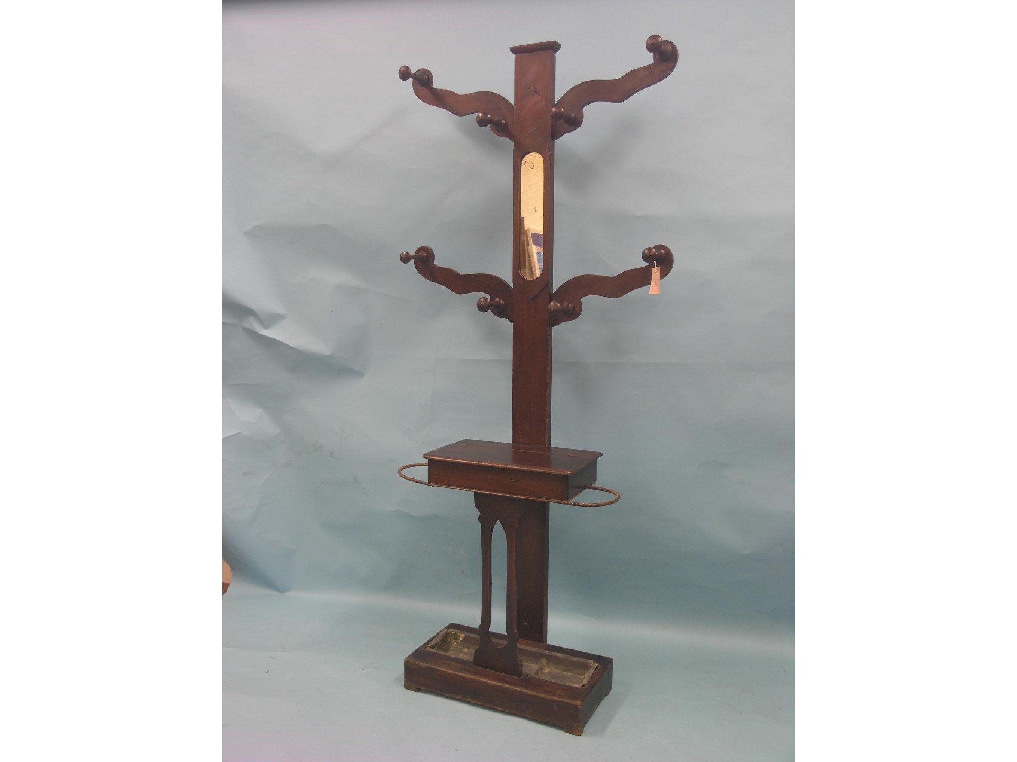 Appraisal: A Victorian mahogany hall stand eight coat hooks above glove