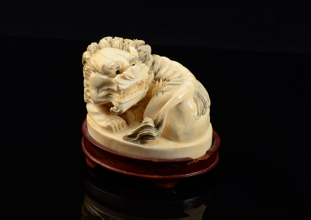 Appraisal: CARVED IVORY CURLED FOO LION SEAL Figure of a foo