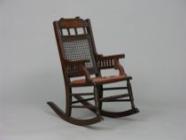 Appraisal: Victorian Child's Rocking Chair Tiny wooden rocker features a string