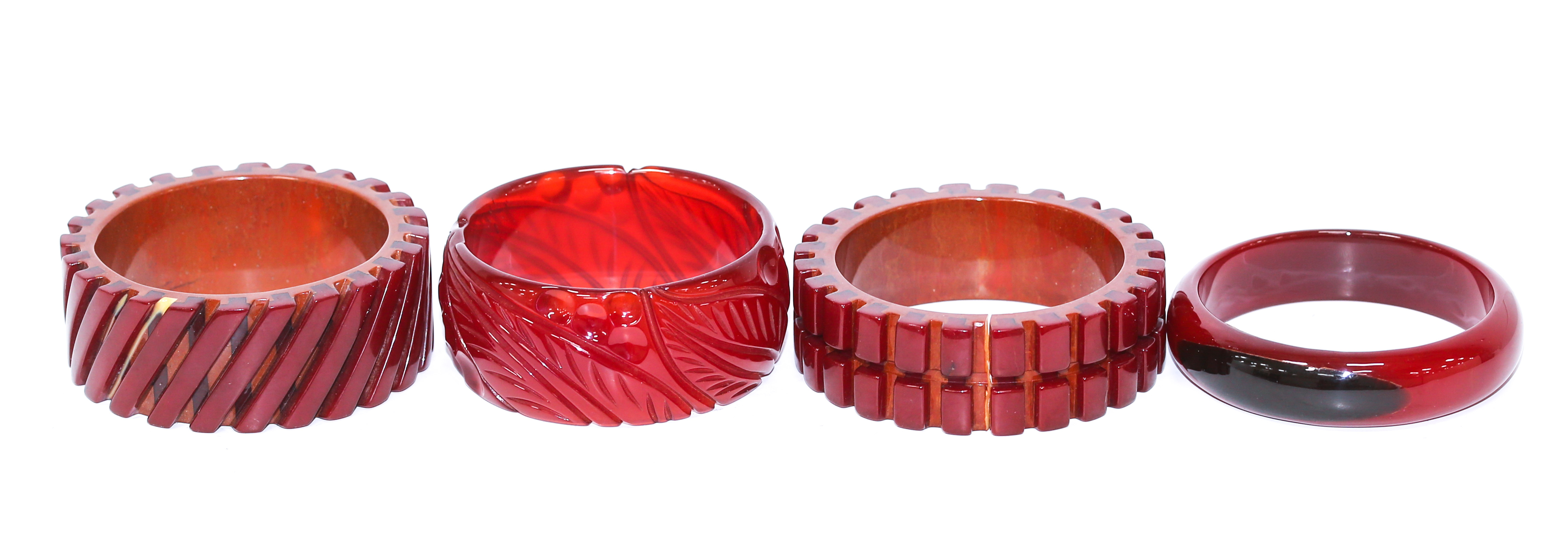 Appraisal: A COLLECTION OF RED BAKELITE BANGLES Including two red tracks