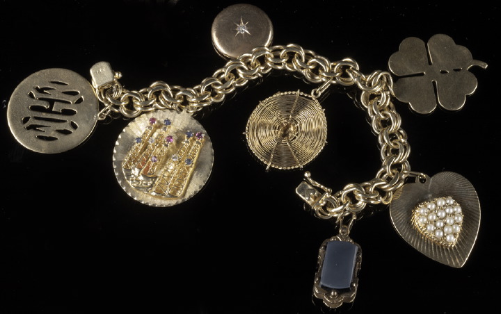 Appraisal: American Fourteen-Karat Yellow Gold Charm Bracelet and Charms composed of