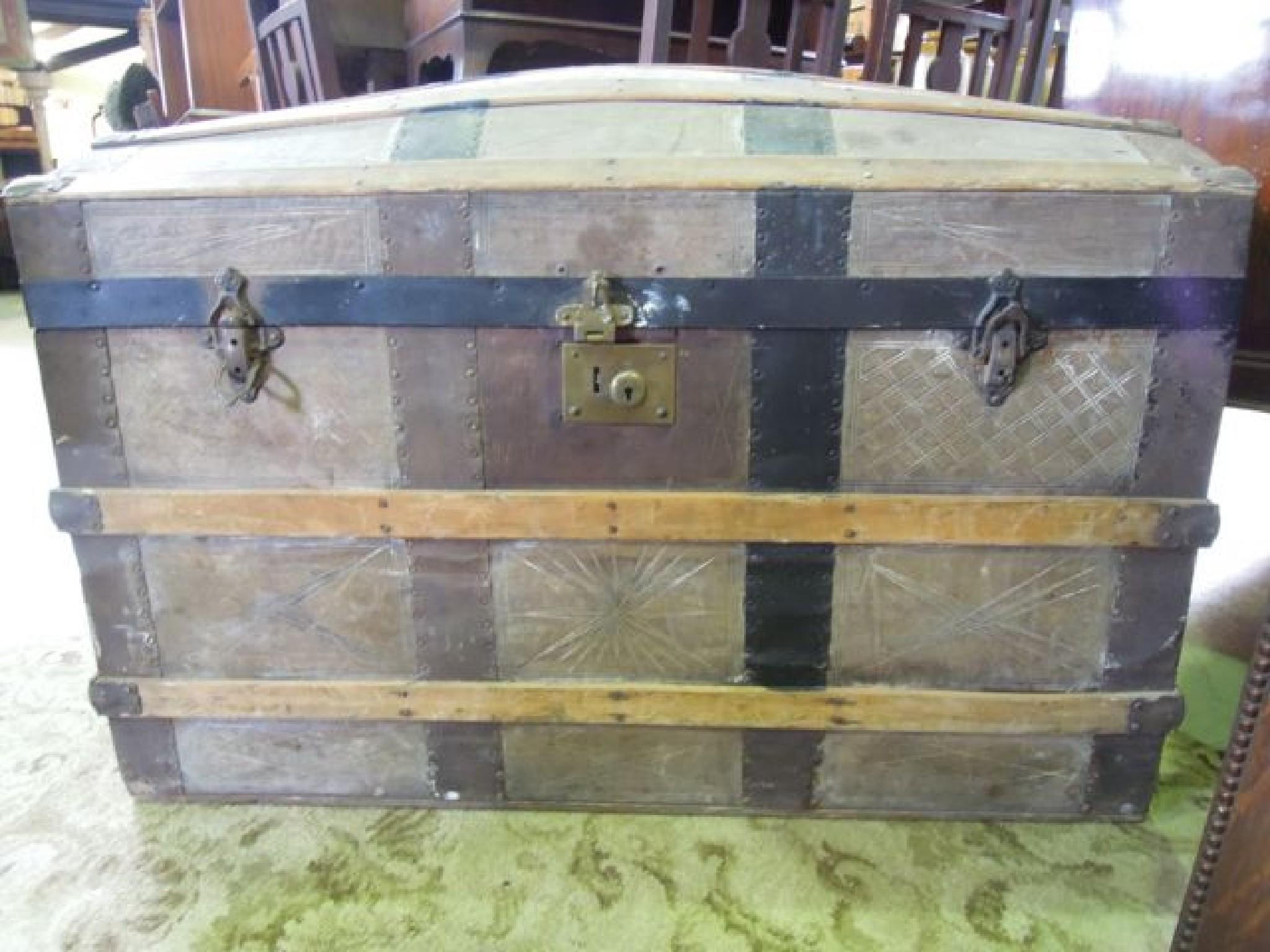 Appraisal: A domed top timber lathe and steel banded travelling trunk