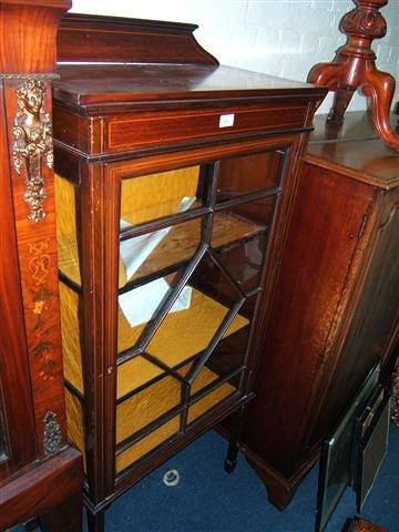 Appraisal: An Edwardian mahogany display cabinet with satinwood stringing and glazed