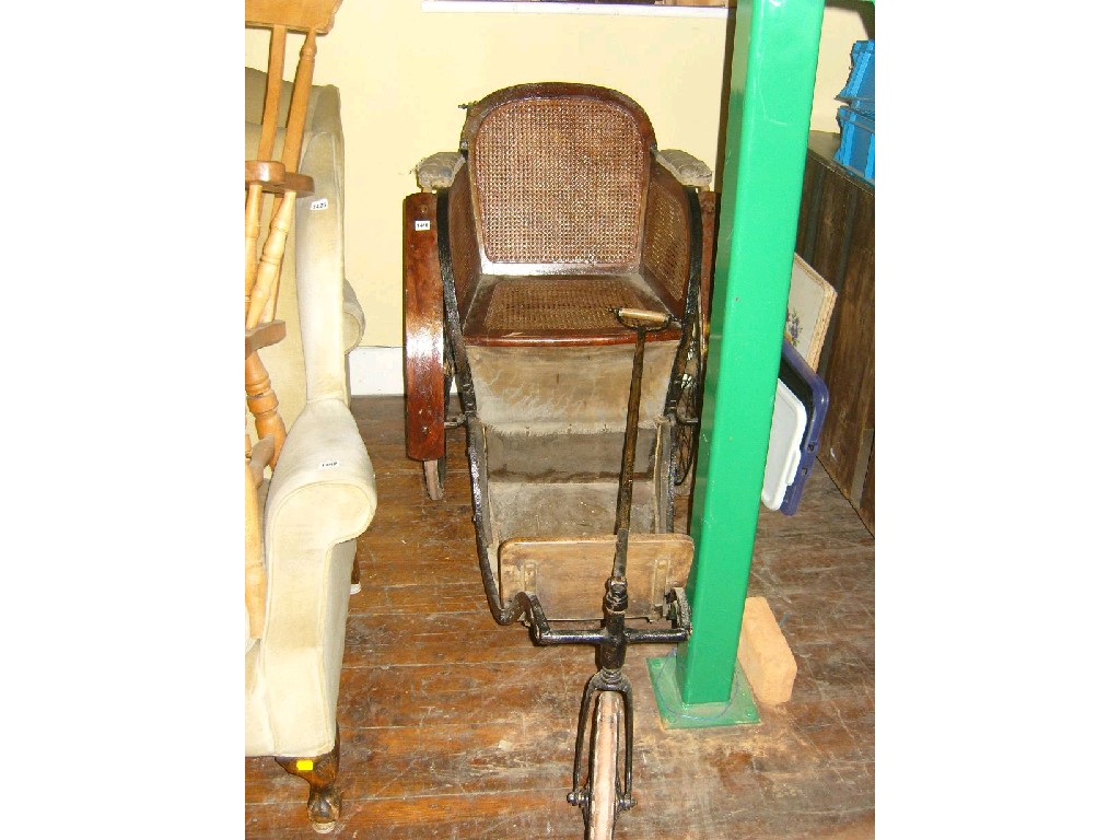 Appraisal: A Victorian -wheeled invalid carriage with cane panelled seat and