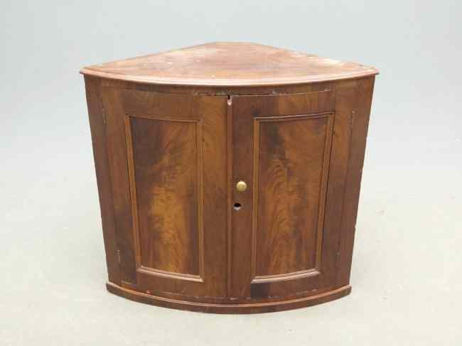 Appraisal: th c English mahogany barrel shaped hanging cupboard '' W