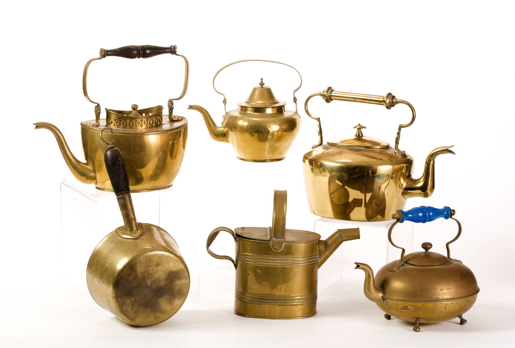 Appraisal: FOUR ENGLISH BRASS TEA KETTLES A WATERING CAN AND A