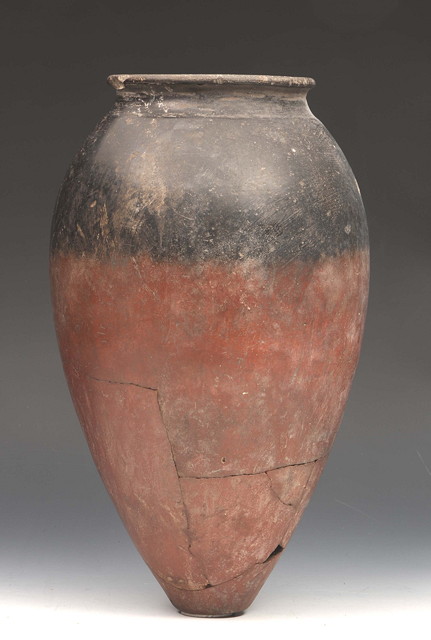 Appraisal: AN ANCIENT EGYPTIAN PRE-DYNASTIC RED POTTERY JAR with black top