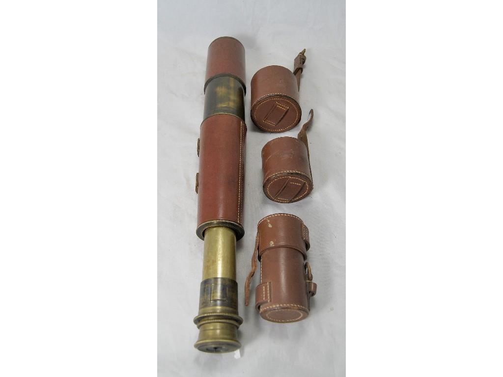 Appraisal: A brass telescope with stitched leather sleeve and end-caps to