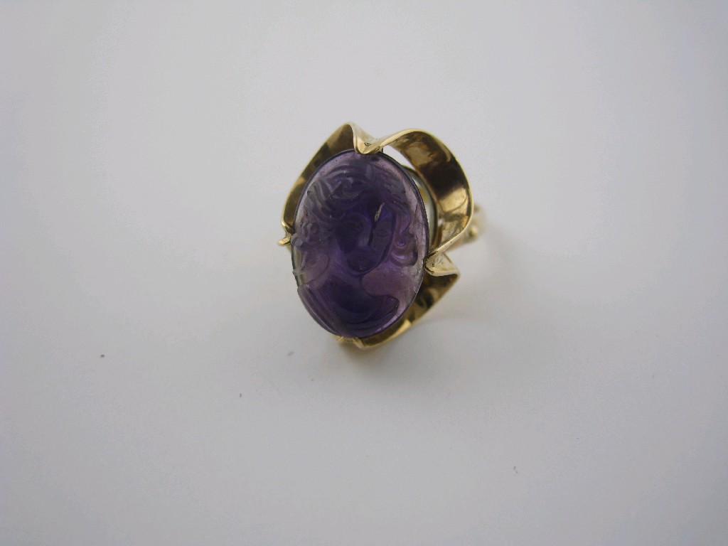 Appraisal: A carved Amethyst Dress Ring the oval stone carved cameo