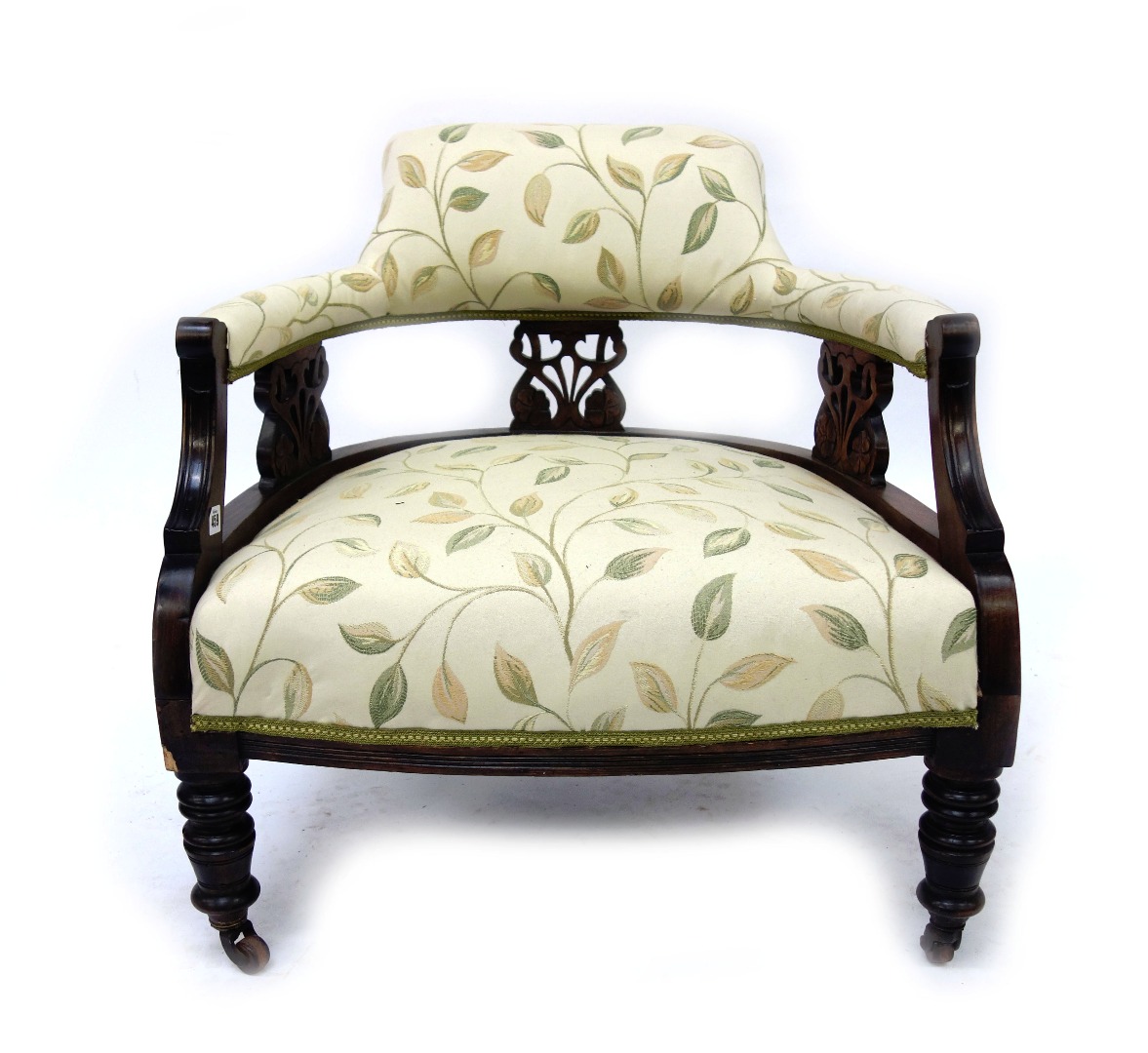 Appraisal: An Edwardian dark stained tub back armchair upholstered in floral