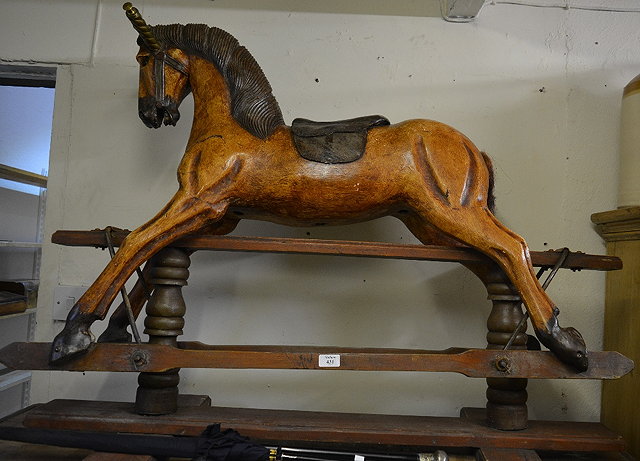 Appraisal: An old painted and carved rocking horseon a stand