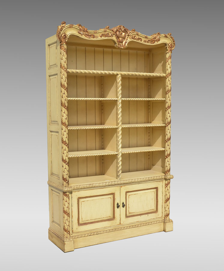 Appraisal: CONTINENTAL CARVED PAINTED BOOKCASE Rococo style with carved foliate crest