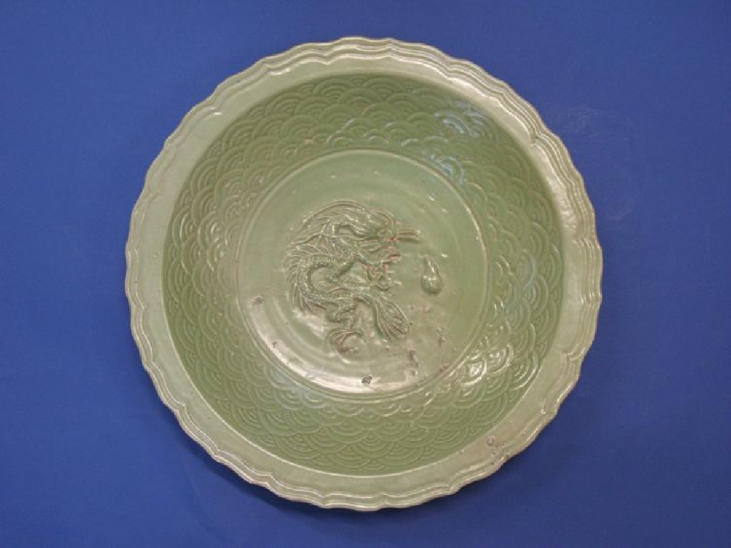 Appraisal: A CHINESE PALE GREEN CELADON CHARGER moulded with a central