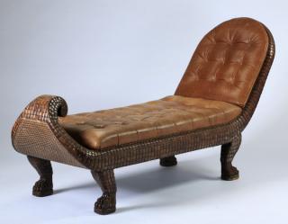 Appraisal: Cane Fgural cane-backed and curled chaise carved in the likeness