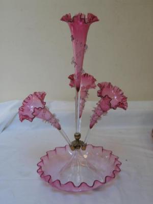 Appraisal: A SHADED CRANBERRY GLASS CENTREPIECE modelled as a central trumpet