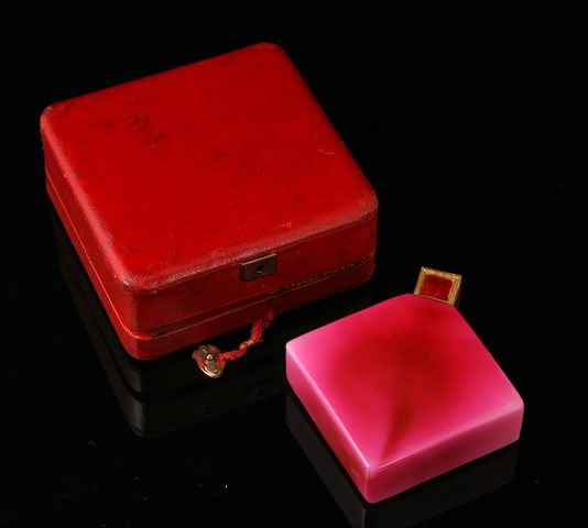 Appraisal: In pink glass with original enamel cap and internal stopper