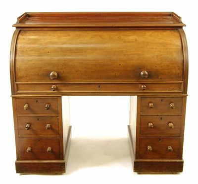 Appraisal: A Victorian mahogany cylinder desk the pull-out writing surface to