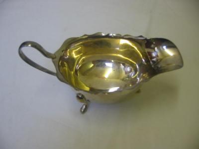 Appraisal: A SAUCE BOAT of oval form with gimped rim plain