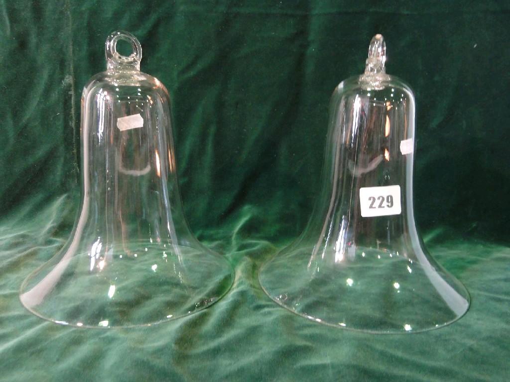 Appraisal: A pair of clear glass bells with flared rims and