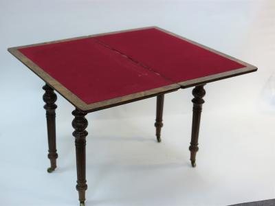 Appraisal: A Victorian figured walnut card table the fold over top