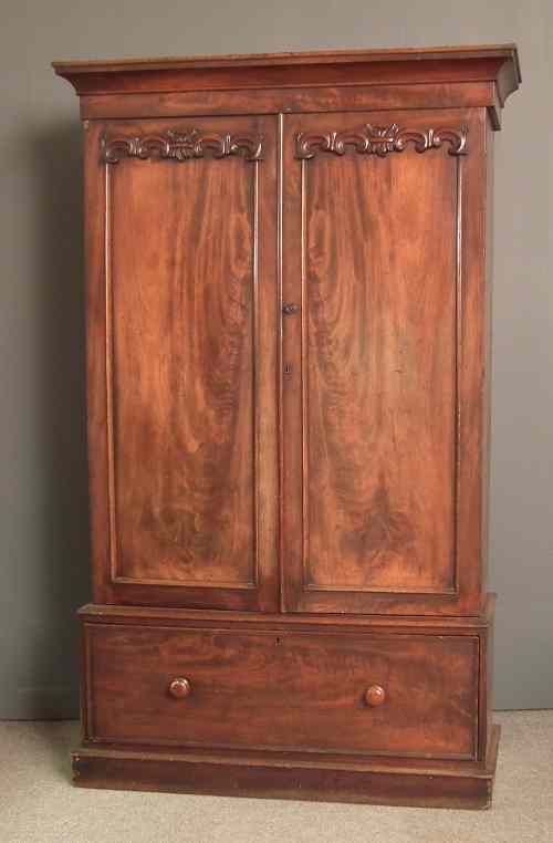 Appraisal: A Victorian mahogany wardrobe the top with flared cornice fitted