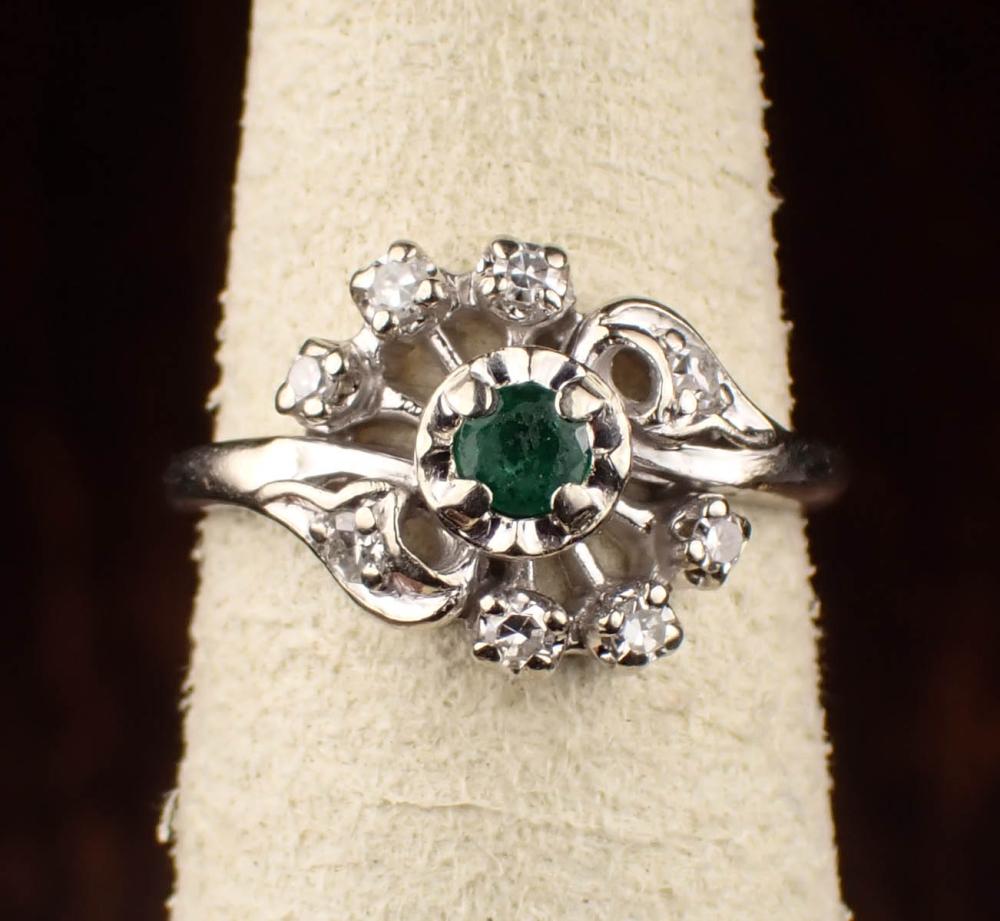 Appraisal: DIAMOND EMERALD AND FOURTEEN KARAT WHITE GOLD RING with six