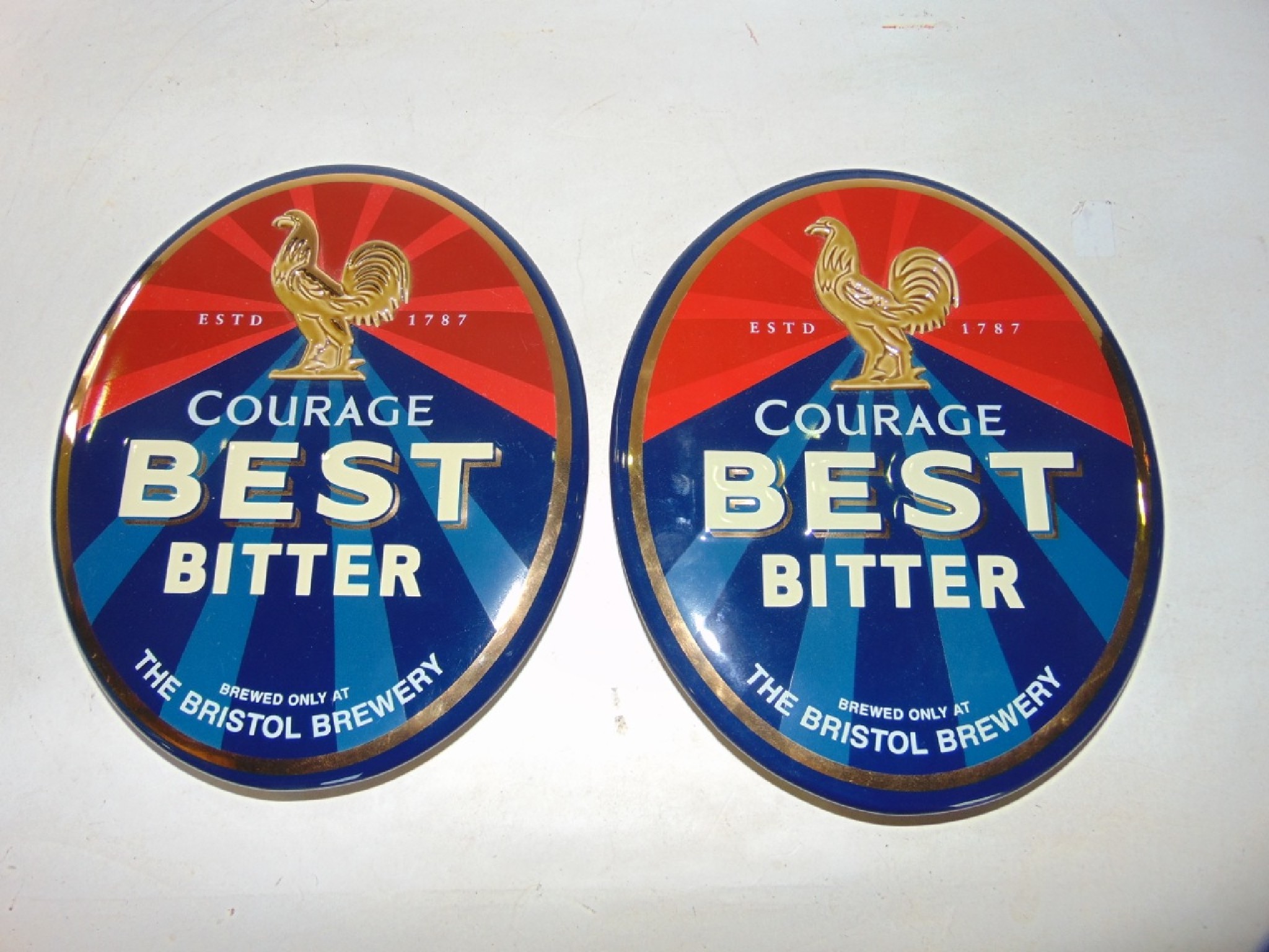 Appraisal: A pair of contemporary ceramic wall plaques for Bristol Brewery