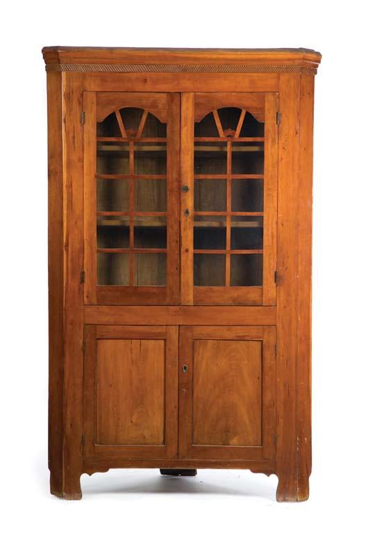 Appraisal: CORNER CUPBOARD Cherry with a molded cornice two glazed doors