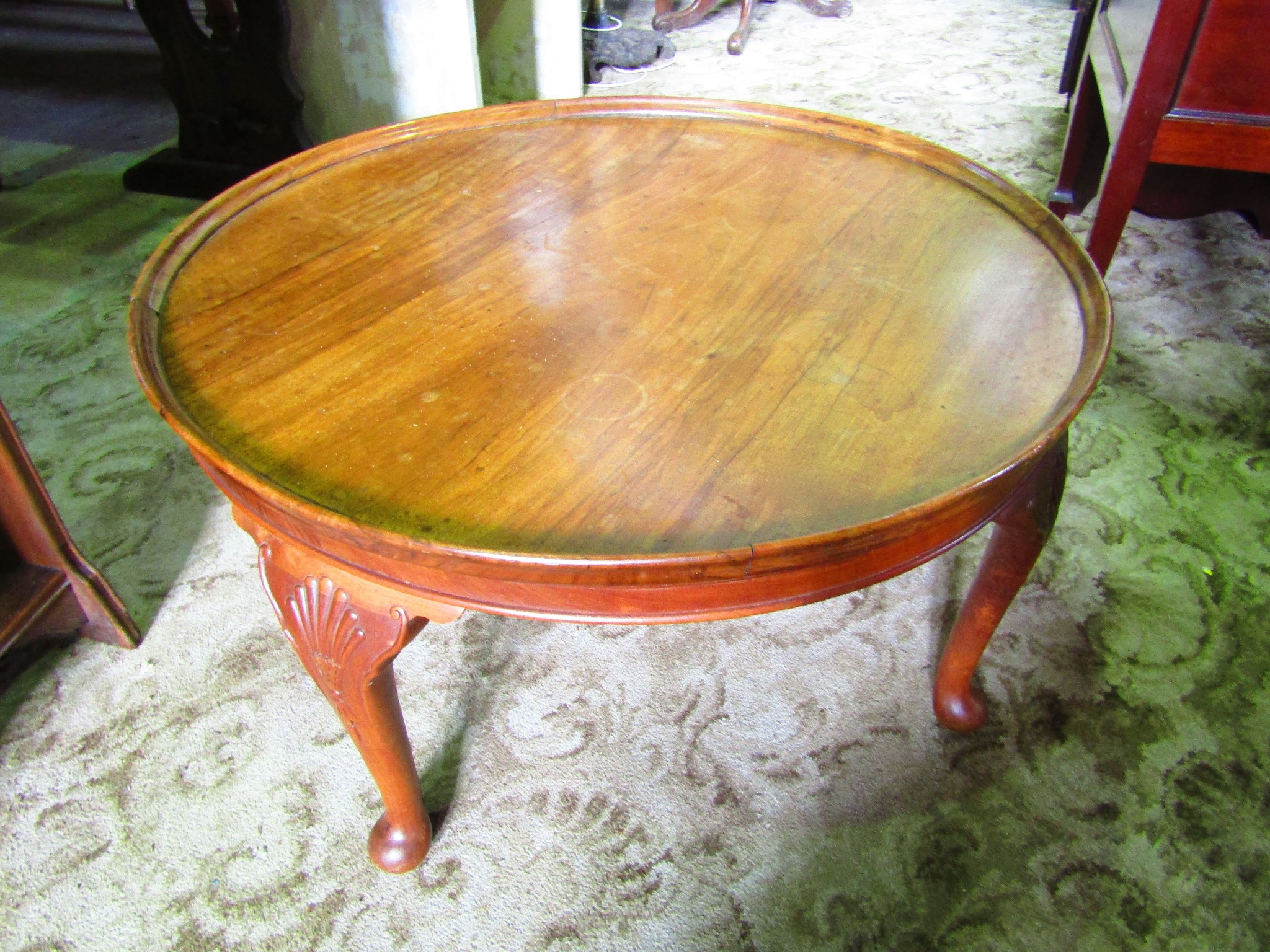 Appraisal: A low walnut veneered tray top occasional table of circular