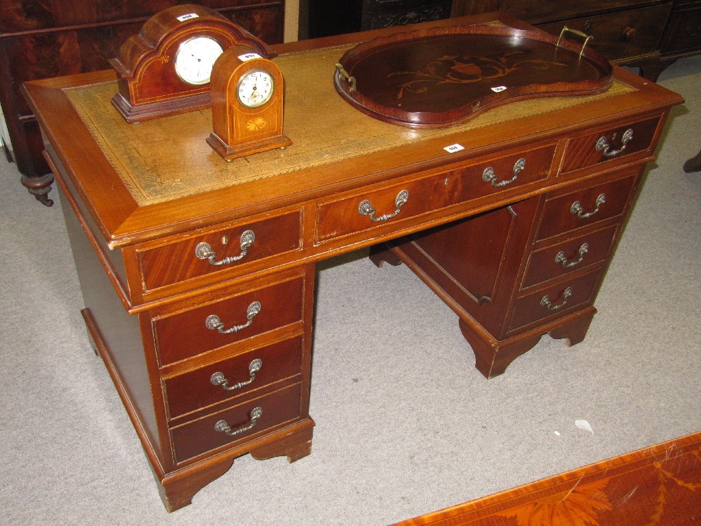 Appraisal: Reproduction mahogany kneehole desk with leather inset top