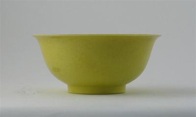 Appraisal: A Chinese yellow glazed bowl with everted rim incised on