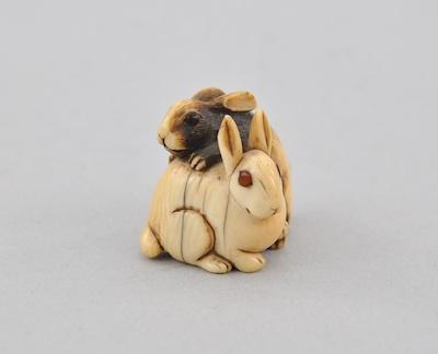 Appraisal: Two Playful Rabbits Okimono Carved ivory with rubbed pigments and