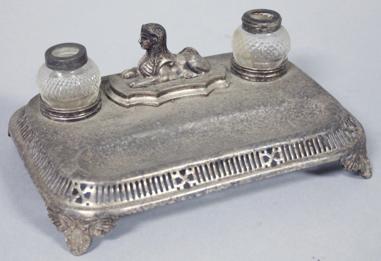 Appraisal: A thC silver plated ink stand centred by a seated