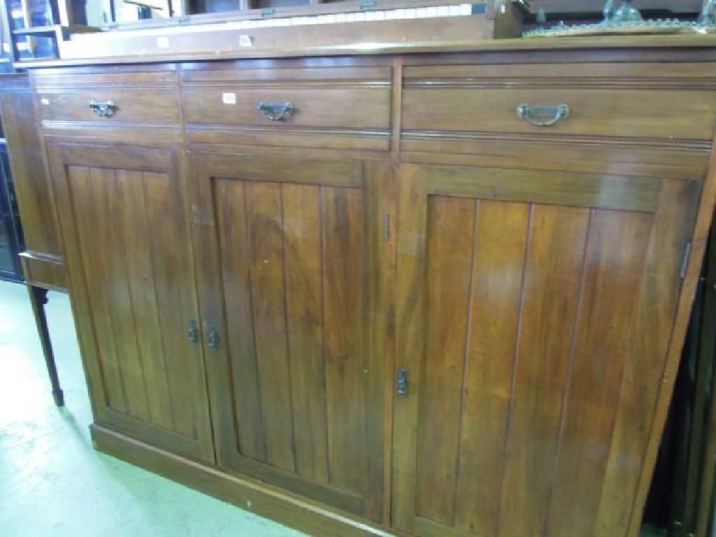 Appraisal: A late Victorian walnut side cupboard fitted with three frieze