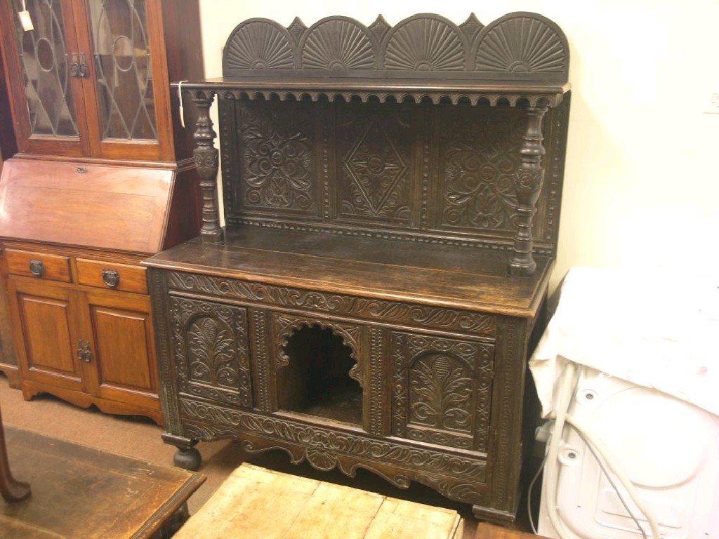 Appraisal: A Victorian dark carved oak dresser overshelf on tall turned